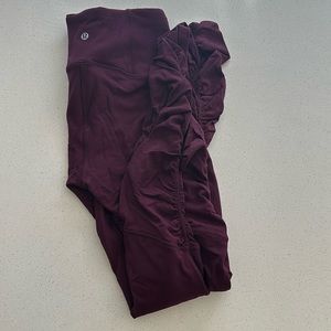 Wine colored Lululemon leggings with rouched bottoms.